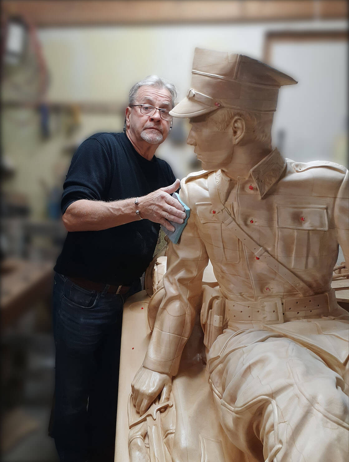 Tadeusz Swiatek working on a wooden statue of a Polish Ulhan